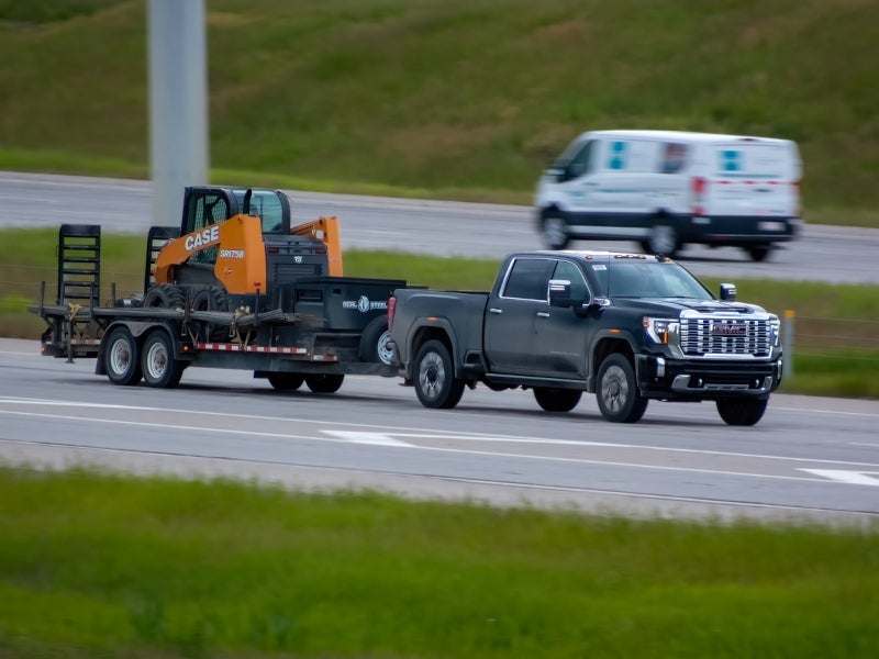 Sierra towing heavy equipment on the highway