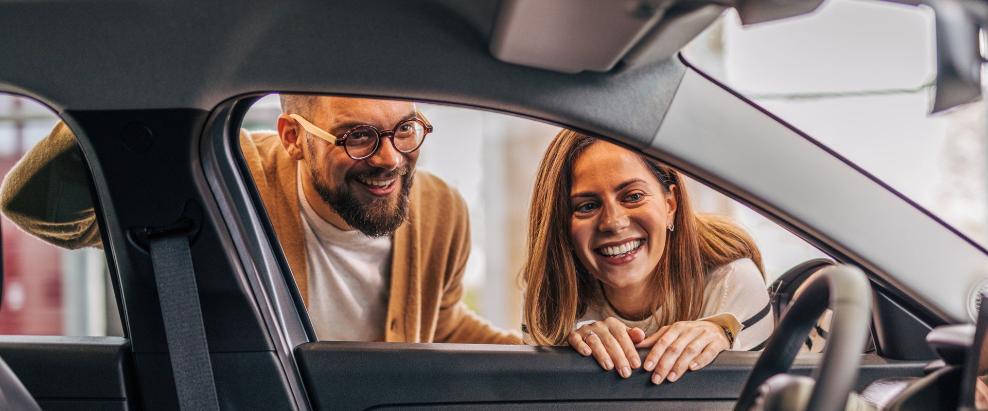 Couple examining GMC vehicle interior